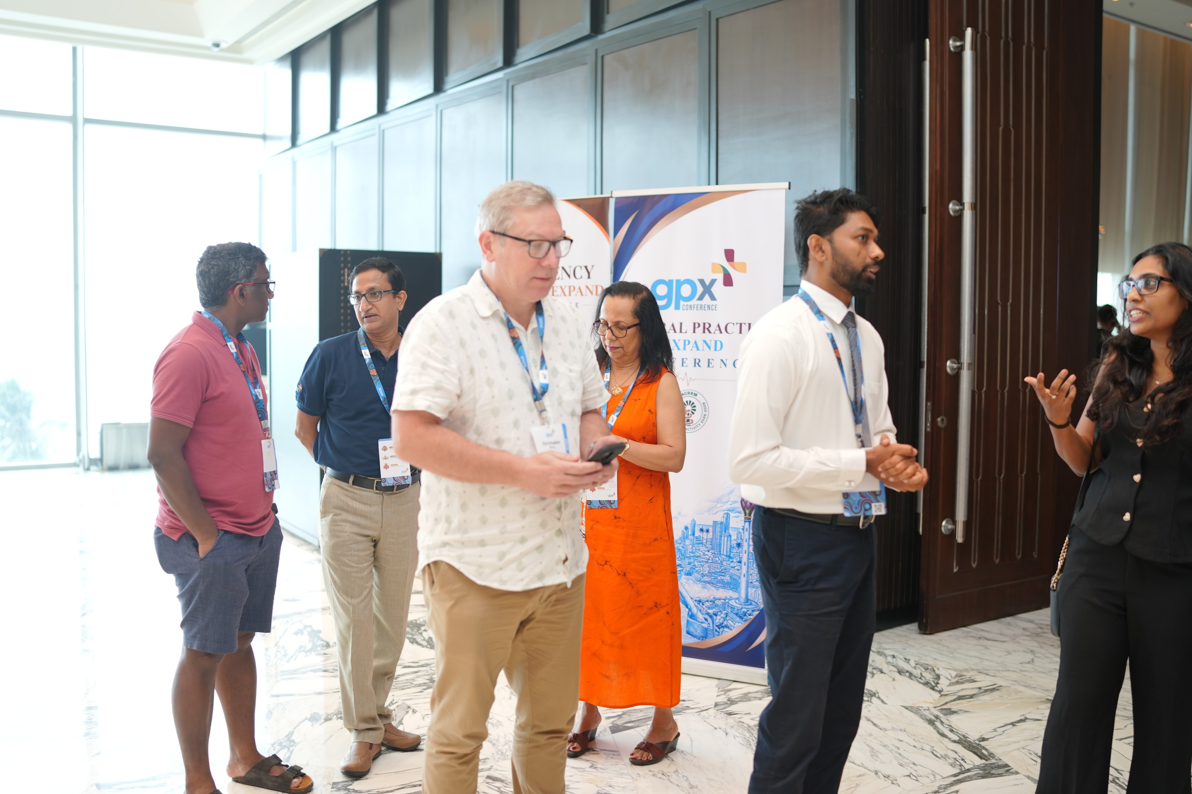 Delegates networking in the foyer at gpx 2026 in front of the conference banner, Colombo, Sri Lanka
