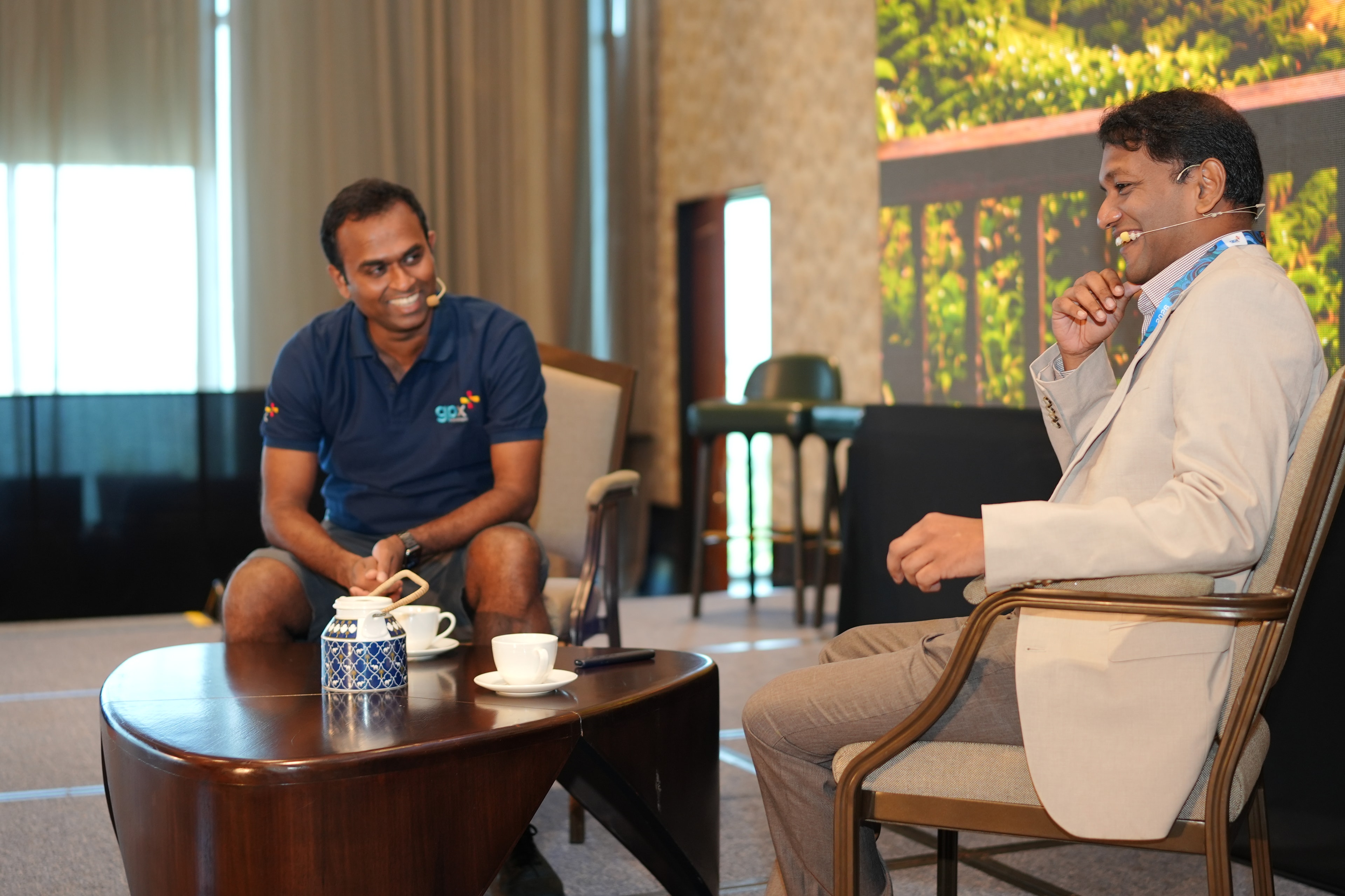 Two delegates in conversation at gpx 2026 in Colombo, Sri Lanka